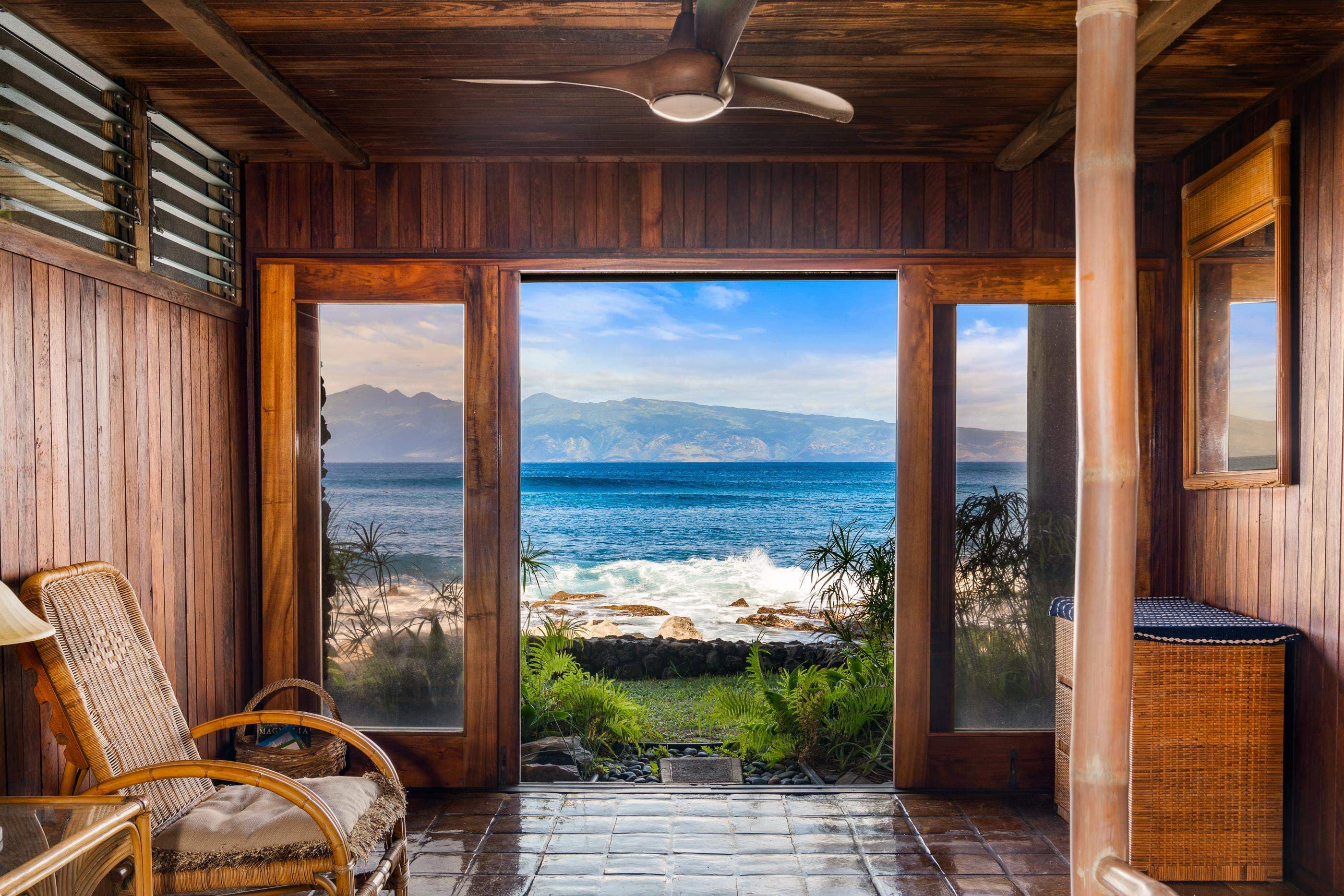 Wicker lounge chairs in the sunroom, a panorama of the channel through the glass